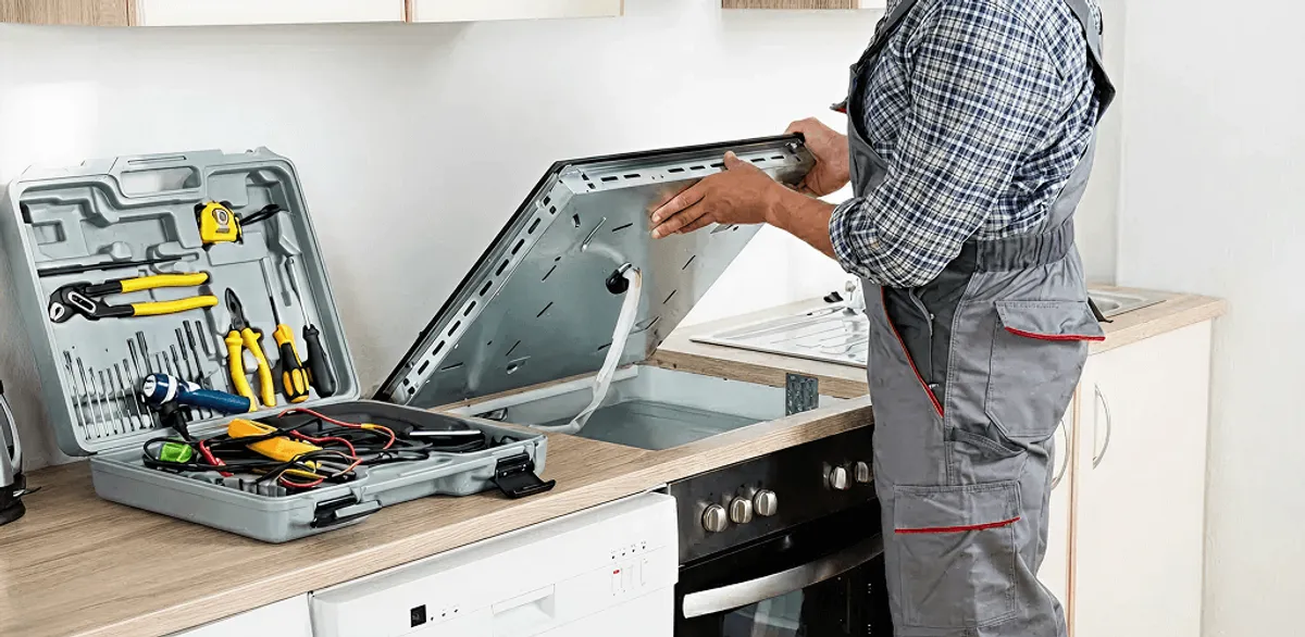 Handyman repairing a cooktop and checking wiring connections in Columbia, SC