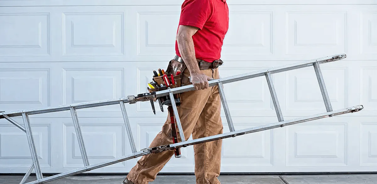 Garage door repair technician arriving with tools and ladder in Columbia, SC