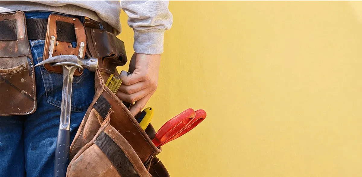 Handyman with tool belt ready for home repairs and maintenance in Columbia, SC