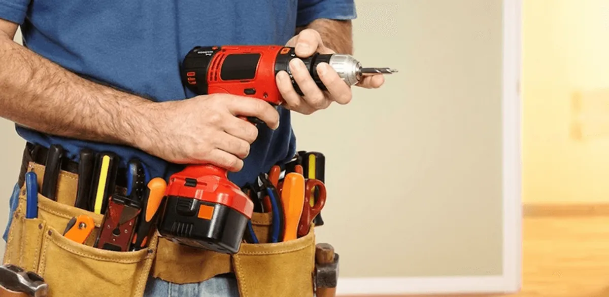 Handyman holding a power drill for home repairs and installations in Columbia, SC